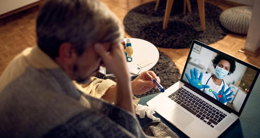 Close-up of female doctor having video call with her patient who is having fever at night at home.